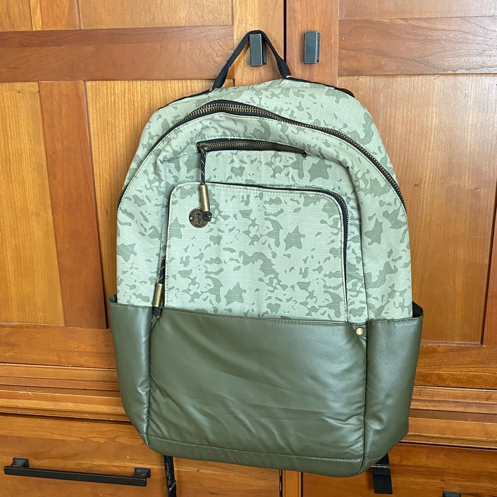 Focused space, green camo laptop, backpack